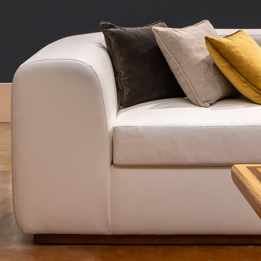 A soft fluffy modern white sofa with 3 cushions