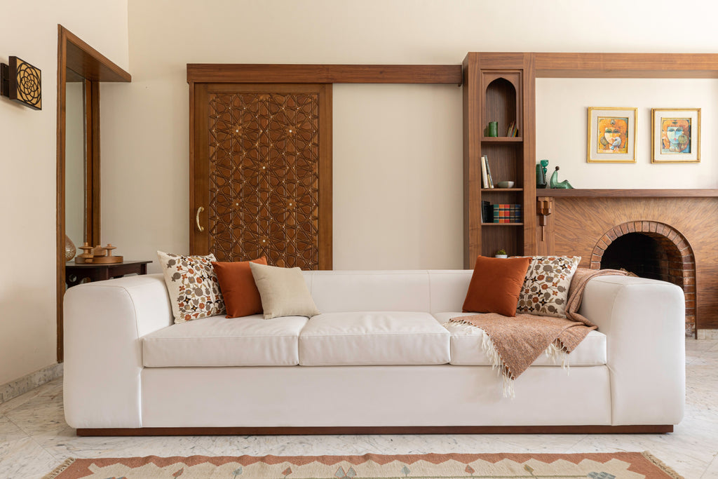 White soft fluffy sofa in room with wooden doors.