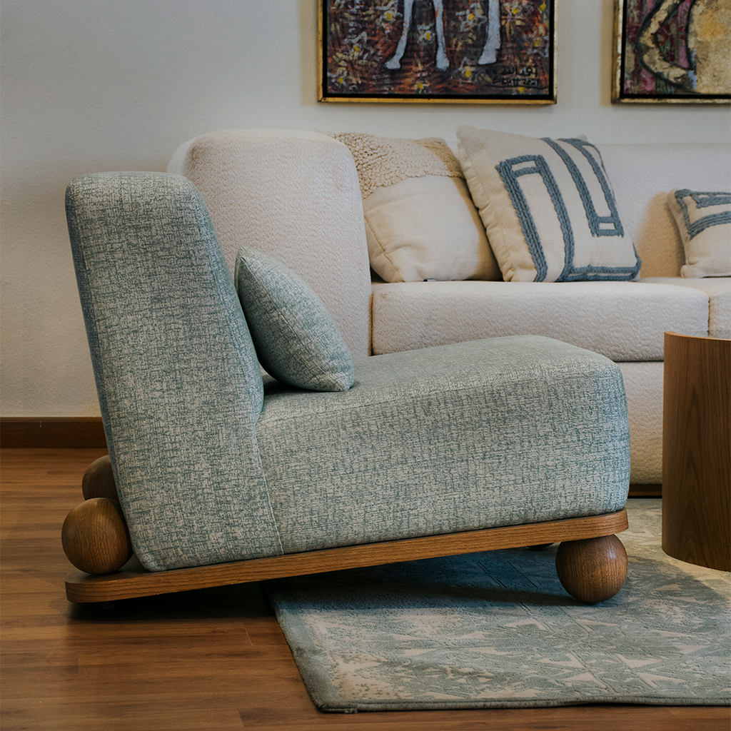  An inviting living room featuring a plush couch and elegant chair.