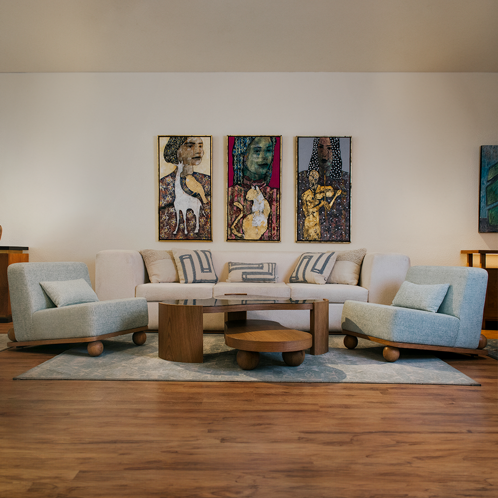  Interior of a living room featuring a couch, coffee table, and two chairs.