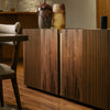 Wooden sideboard with a vase, adding elegance to the room decor.